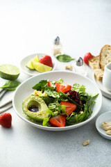 Healthy leaf salad with strawberry and avocado
