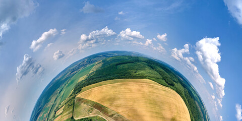 Aerial view from high altitude of little planet earth with yellow cultivated agricultural fields...