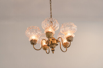 Beautiful retro brass chandelier ceiling lamp decoration for home and living and wall background with copy space.