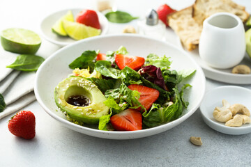 Healthy leaf salad with strawberry and avocado