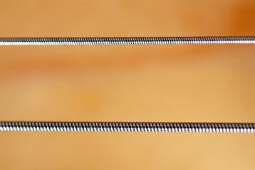 Stringed instrument music background, macro detail of metal chords of electric guitar