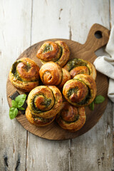 Homemade pastry rolls with pesto sauce
