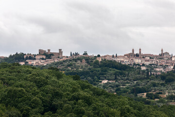 Fototapeta na wymiar Clear panoramic view over the hilltop of Montalcino medieval town with The Rocca, Fortress and Duomo, Tuscany, Italy