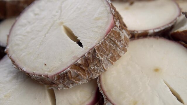 Fresh sliced cassava root. Yucca dry plant. Manioc slices. Macro. Rotation
