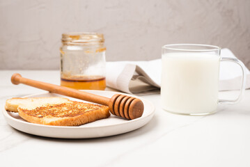 Croutons for breakfast with honey and milk.
