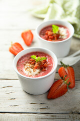 Homemade strawberry soup with chocolate and cream