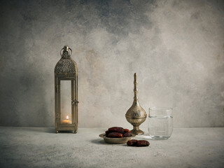 Ramadan concept, presentation of dates with Turkish culture zinc tray and candle, lamp, lifestyle decor, Islamic background.