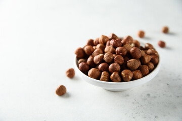 Organic hazelnut in a white bowl