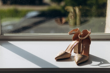 wedding shoes of the bride on the window