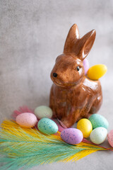 Little easter bunny, feathers and colorful eggs, decoration ideas.