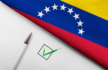 Pencil, Flag of Venezuela and check mark on paper sheet
