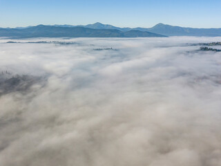 Morning mist in Ukrainian Carpathian mountains. Aerial drone view.