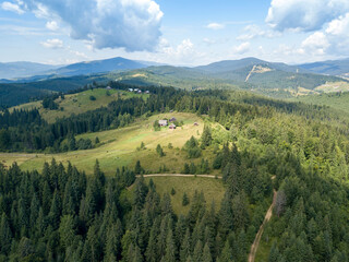 Naklejka premium Green mountains of Ukrainian Carpathians in summer. Sunny day. Aerial drone view.