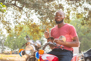 okada rider using his phone, thumbs up gesture