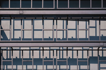 Fototapeta premium Sunlight and shadow on surface of black metal wall decoration outside of modern steel structure house in industrial loft style