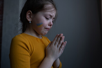 Upset Ukrainian girl kid homeless protesting war conflict. No War. Crisis, peace, stop aggression,...