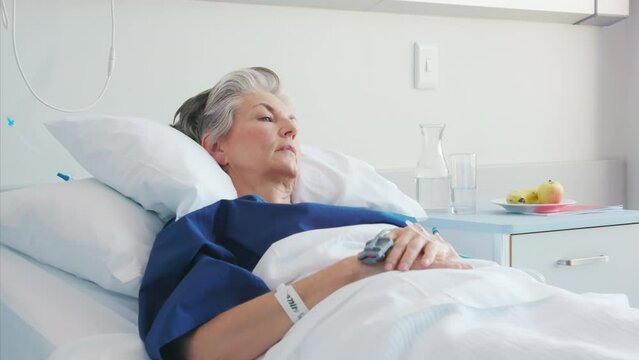 Lonely old woman lying on hospital bed