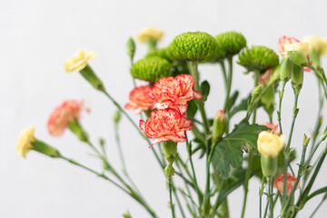 Colorful flowers composition over grey background with copy space. Fresh cut flowers for decoration home. Flower arrangement in a vase for home. Women's Day and spring time flower background