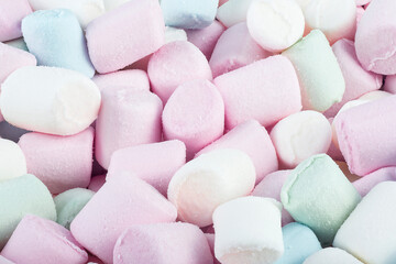 Background or texture of colorful mini marshmallows, top view. Marshmallow pastel colors.