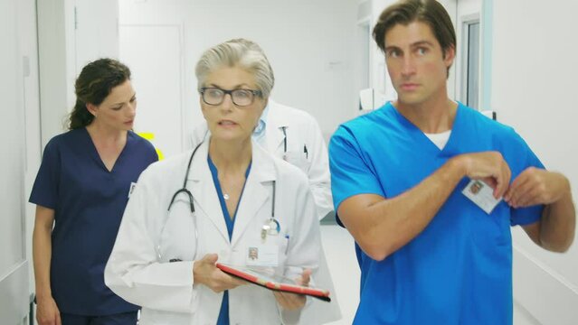 Doctor and nurses discussing patient case at hospital