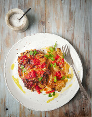 Pork chops with onion, bell peppers and cheese