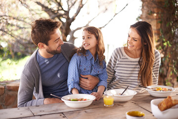 Delightful breakfast time. Cropped shot of a family having a meal together outside.