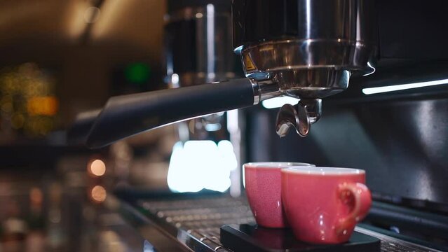 barista preparing hot espresso coffee in cup and with professional machine