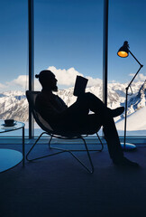 Man reading book in the hotel room with Mountain View