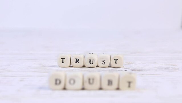 Wooden blocks with Doubt sign going to Trust. High quality 4k video.