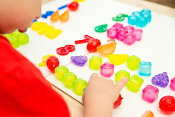 Numbers and toys. Artificial fruits and digits. Idea for children learning to count. Montessori concept, early education.