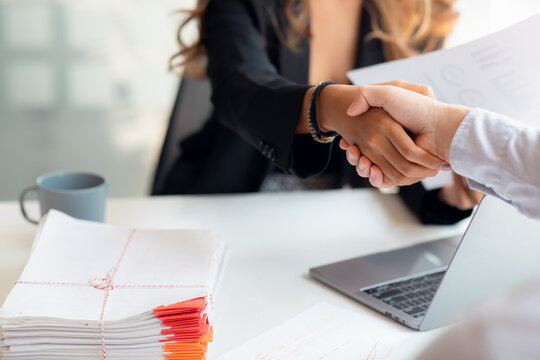 Negotiating business,Image of businesswomen Handshaking,happy with work,the woman she is enjoying with her workmate,Handshake Gesturing People Connection Deal Concept