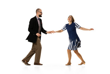 Couple of dancers, young man and woman in vintage retro style outfits dancing swing dance isolated on white background. Timeless traditions, 60s, 70s fashion style.