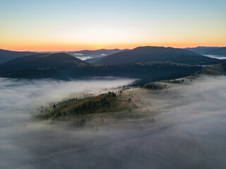 Obraz premium Morning fog in the Ukrainian Carpathians. Aerial drone view.