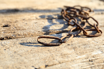 close-up old rusty chain on wooden background