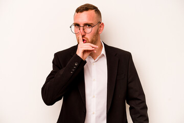 Young business caucasian man isolated on white background keeping a secret or asking for silence.