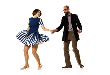 Social dancing. Couple of dancers, young man and woman in vintage retro style outfits dancing swing dance isolated on white background. Timeless traditions
