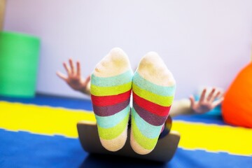 autistic girl in colorful lgbt socks lies as a demonstration of independence and freedom of feelings