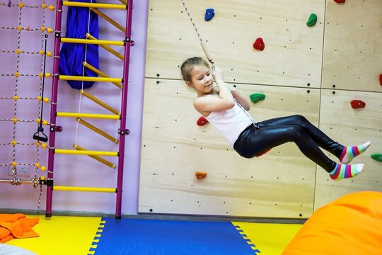 an autistic girl is being treated at the center by a psychologist, swing exercises help the brain, balance, cerebellum