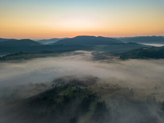 Obraz premium Morning fog in the Ukrainian Carpathians. Aerial drone view.
