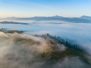 Morning mist in Ukrainian Carpathian mountains. Aerial drone view.