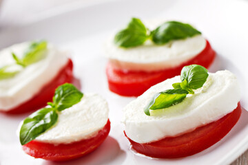 Caprese Salad with tomatoes, basil, mozzarella, olive oil. Mediterranean, organic and natural food concept