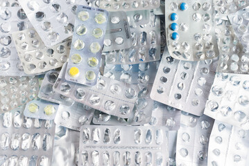 Empty drug blisters and some colored pills.