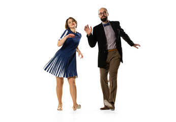 Happy young man and woman in vintage retro style outfits dancing lindy hop dance isolated on white background. Timeless traditions, 60s, 70s fashion style.