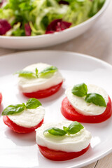 Caprese Salad with tomatoes, basil, mozzarella, olive oil. Mediterranean, organic and natural food concept