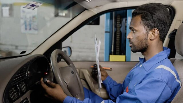 Car Mechanic writing down problems of car while at repair or maintenance service for budget estimation at garage - concept of expertise, professional occupation and automobiles