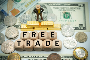 free trade is the opposite of trade protectionism or economic isolationism.free trade agreement.laissez-faire trade or trade liberalization.The word is written on  money and gold background - obrazy, fototapety, plakaty