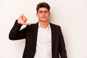 Young caucasian business man isolated on white background showing a dislike gesture, thumbs down....