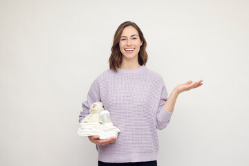 Portrait of a happy and beautiful mother with a big smile on her lips and diapers, teddy and baby...
