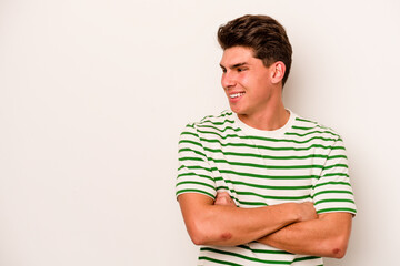 Fototapeta premium Young caucasian man isolated on white background smiling confident with crossed arms.