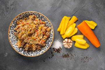 Pilaf - Rice with Meat and Vegetables. Garnished with Onions and Tomatoes Salad